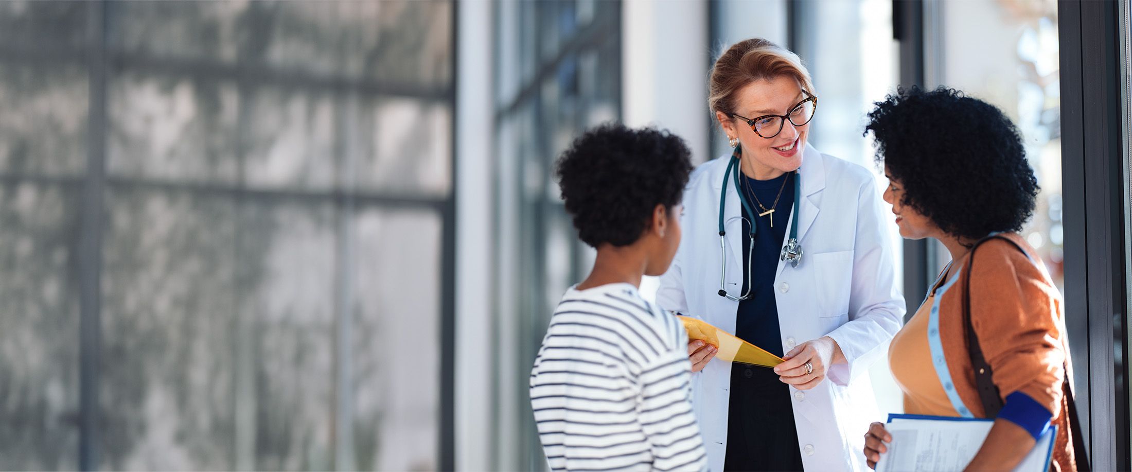A doctor talking with a mother and her child