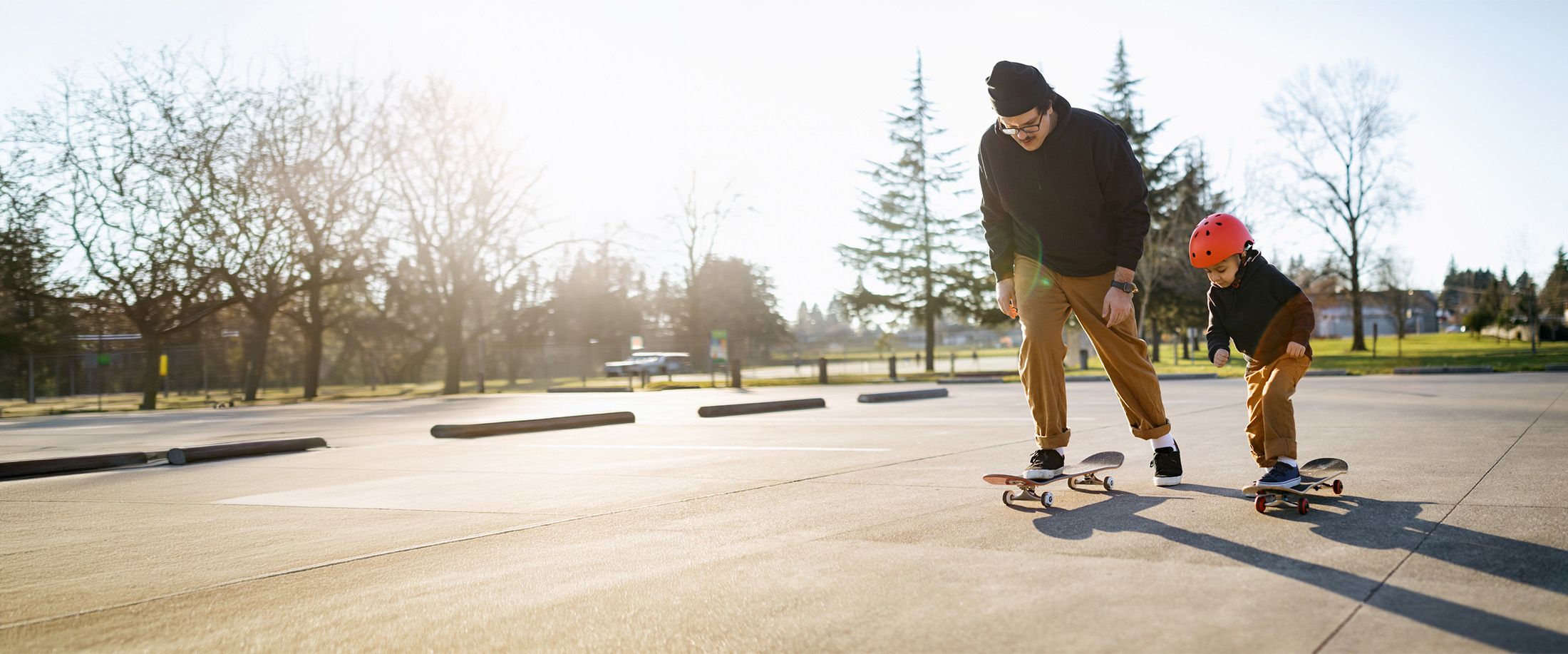 A father teaching his young son to skateboard