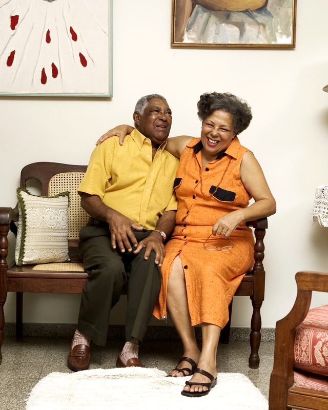 An older couple laughing together at home