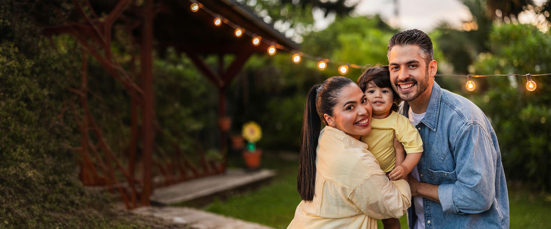 A family together in their backyard at dusk